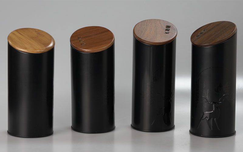 What are the differences between embossed and printed black metal tins